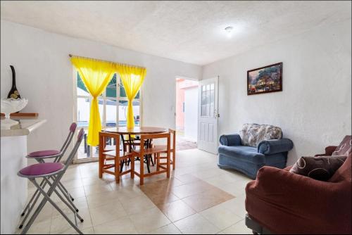 a living room with a table and chairs and a couch at KingsLanding in Morelos