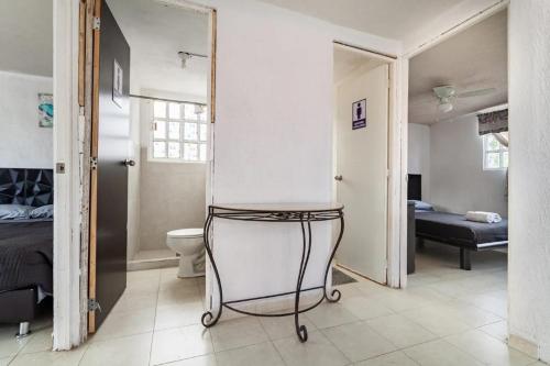 a bathroom with a chair in a room at KingsLanding in Morelos