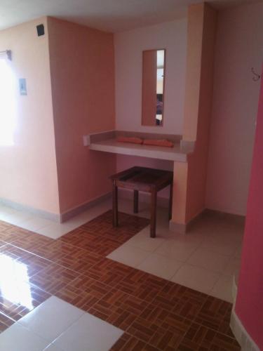 a room with a table and a bench in it at Motel Champoton sobre carretera frente al mar in Champotón
