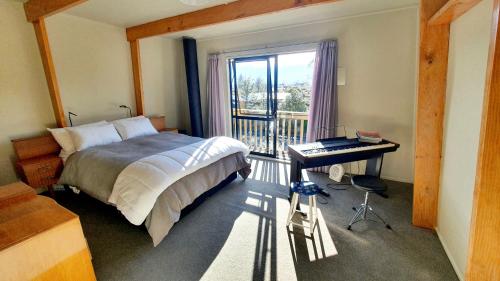 1 dormitorio con cama, escritorio y ventana en Mountain Chalet - National Park Township, en National Park