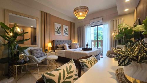 a living room with a bed and a couch at Alpine Villas Greens Staycation at Crosswinds Tagaytay in Tagaytay