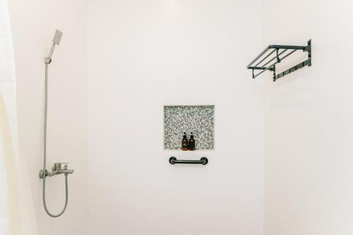 a bathroom with a shower with a glass door at La Joya Farm Resort & Spa in Aloguinsan