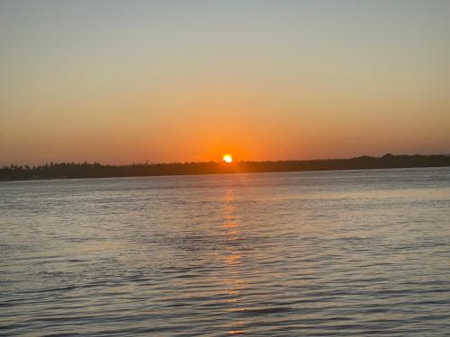 a sunset over a large body of water at Airamjudi in Watamu