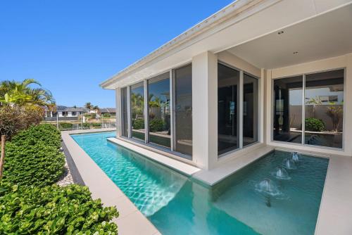 an image of a house with a swimming pool at Pay for 3 nights, get 4th night for free in March in Mooloolaba