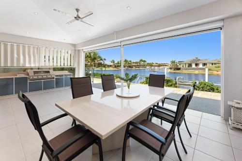 a dining room with a table and chairs at Pay for 3 nights, get 4th night for free in March in Mooloolaba