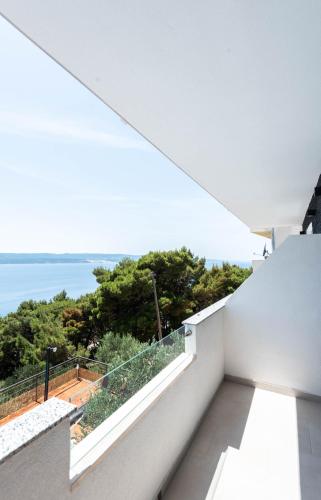 a white balcony with a view of the ocean at Angeli Del Mare in Marusici 