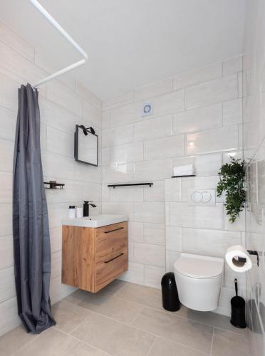 a white bathroom with a sink and a toilet at Angeli Del Mare in Marusici 