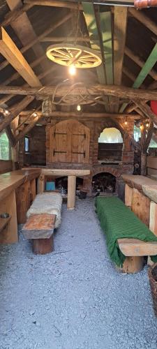 Zimmer mit Holztischen und -bänken in einem Gebäude in der Unterkunft Świerkowy Zakątek u Bacy in Wieprz