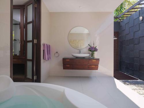 a bathroom with a sink and a mirror at The Ayu Kintamani Villa at Toya Devasya in Kintamani