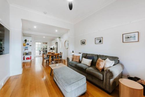 a living room with a couch and a table at Kareela Cottage - A Charming Country Getaway in Mudgee