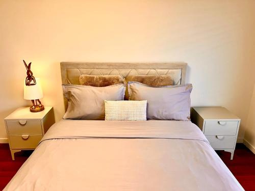 a bedroom with a bed with white sheets and pillows at Luxury Penthouse near the Beach in Antibes