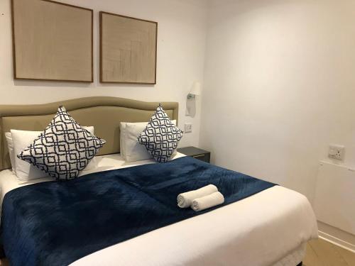 a bedroom with a bed with blue sheets and pillows at Bluebanana Lodge in Mthatha