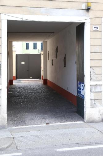 a garage with a door in the side of a building at A Casa Dei Gonzaga, MantegnaHotels in Mantova