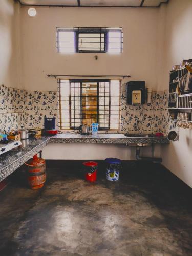 a kitchen with a sink and a window in a room at Upasana Homestay in Dibrugarh