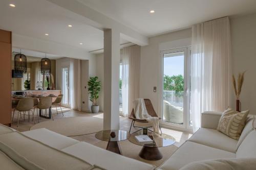 a living room with a white couch and a table at Acropolis View Plunge Pool Loft in Athens