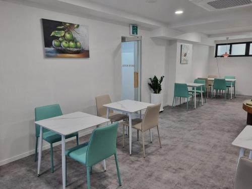 a waiting room with tables and chairs in a restaurant at DAOR Hotel in Busan
