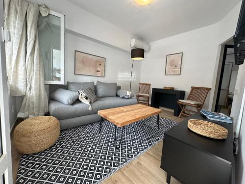 a living room with a couch and a table at La Perla de Sa Riera in Begur