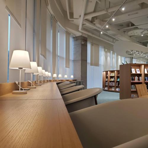 a row of chairs and tables in a store at Busan Station BOOKING THE BAY in Busan