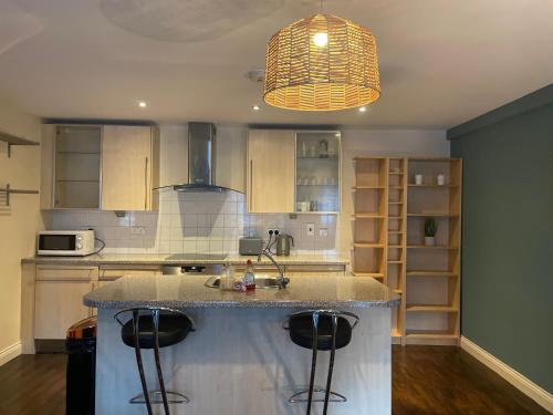 a kitchen with a island in the middle of a kitchen at 69D Victoria Street in Sheffield