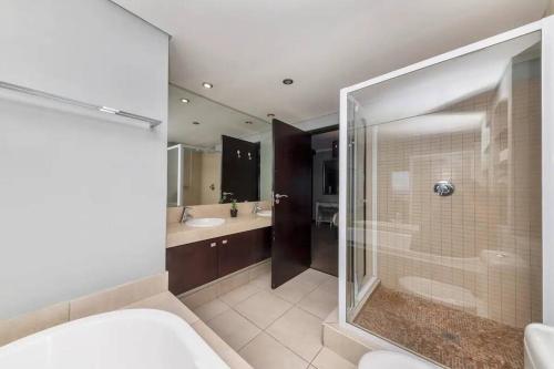 a bathroom with a shower and a toilet and a sink at The Icon Capetown in Cape Town