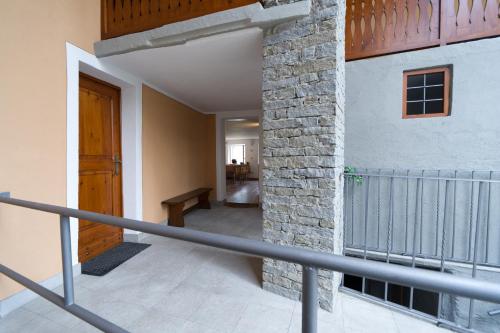 a staircase with a stone pillar and a wooden door at L'Intimità in Aosta