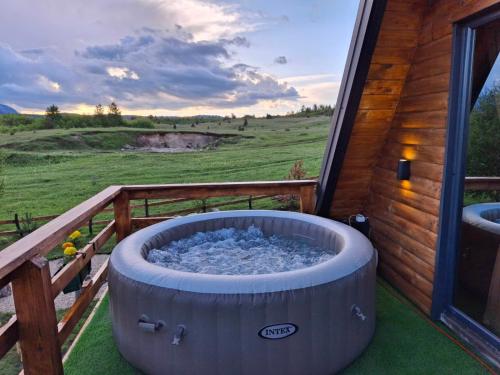 a hot tub on the porch of a house at Villas Sunny Hill in Žabljak