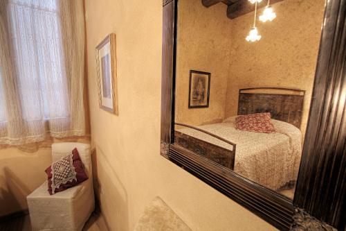 a bedroom with a mirror and a bed in it at La Fornasaccia in Cesena