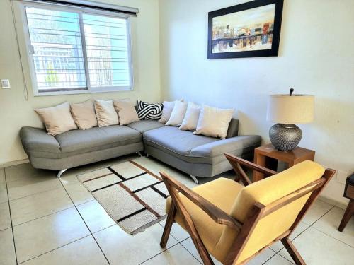 a living room with a couch and chairs in it at Casa para grupos grandes por el ITESO in Guadalajara