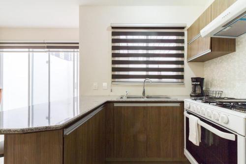 a kitchen with a sink and a stove at Casa para grupos grandes por el ITESO in Guadalajara