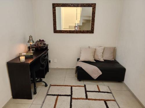 a bedroom with a bed and a desk and a mirror at Casa para grupos grandes por el ITESO in Guadalajara