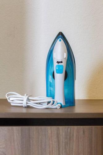 a blue and white electric toothbrush sitting on a shelf at Casa para grupos grandes por el ITESO in Guadalajara