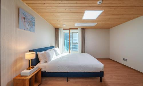 a bedroom with a large bed and a window at Busan Station BOOKING THE BAY in Busan