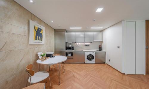 a kitchen with a table and chairs in a room at Busan Station BOOKING THE BAY in Busan