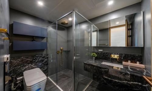 a bathroom with a glass shower and a sink at Busan Station BOOKING THE BAY in Busan