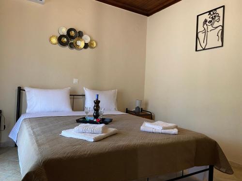 a bedroom with a bed with two towels on it at Summer Home in Potos