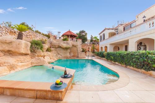 a swimming pool in the middle of a house at Villa & Pool Apartments in Mellieha Bay in Mellieħa