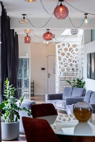 a living room with blue couches and a table at Thome Vlaicu170 Jacuzzi in Cluj-Napoca