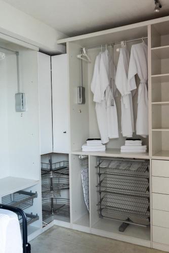 a walk in closet with white cabinets at Thome Vlaicu170 Jacuzzi in Cluj-Napoca
