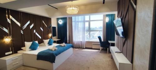 Un dormitorio con una cama con dos ositos de peluche. en Hotel Tajikgrey Dushanbe en Dusambé