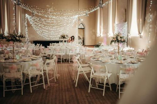 a room filled with tables and chairs with lights at UKI Puhkeküla in Ranna