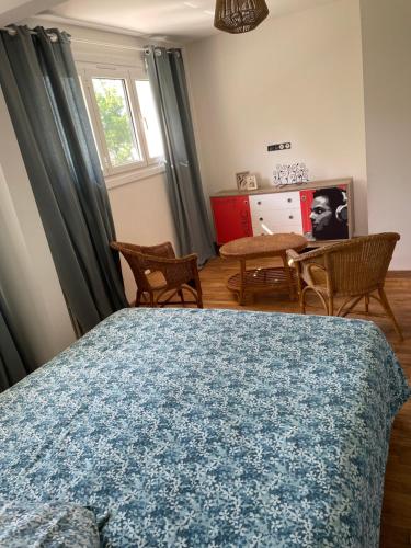 - une chambre avec un lit, des chaises et une table dans l'établissement Agréable chambre, à Ussac