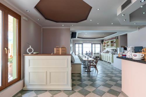 a restaurant with a counter with chairs and tables at Avra in Parga
