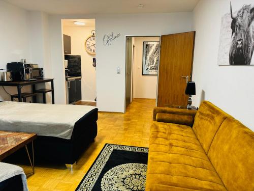a living room with a couch and a bed at Offline 51 City Apartments in Düsseldorf