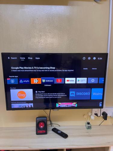 a flat screen tv sitting on top of a table at House of Healing Homestay in Kampong Sura Tengah