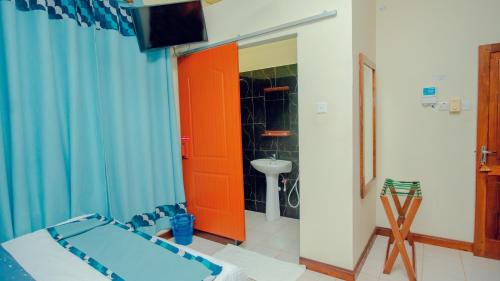 Postel nebo postele na pokoji v ubytování La Casa Preciosa in Tanga