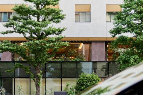 a building with a tree in front of it at The Royal Park Hotel Ginza 6-Chome in Tokyo