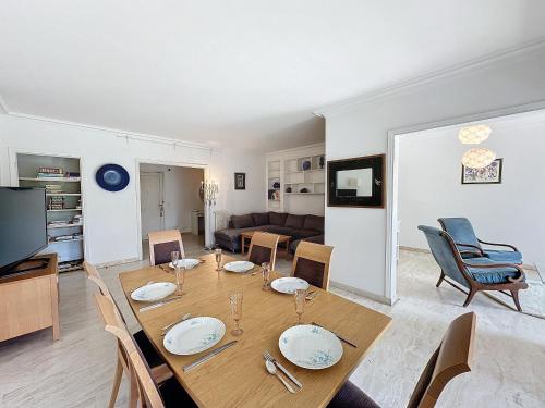une salle à manger et un salon avec une table et des chaises dans l'établissement 130m2 Terrasses, Jardin, 4chambres, Climatisation, à Cannes