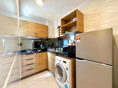 a kitchen with a washer and a dishwasher at TimurBay Seafront Residence Kuantan in Kuantan