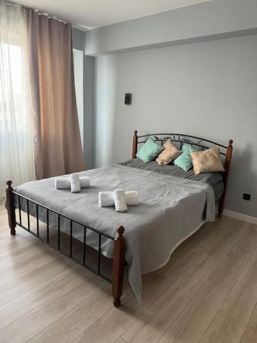 a bedroom with a bed with towels on it at Современная квартира в Алматы для 4 человек in Shugyla