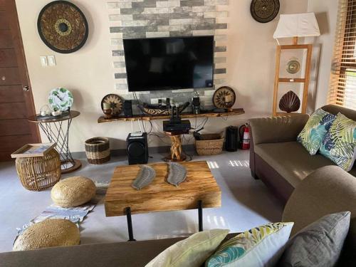 a living room with a couch and a coffee table at RedBeach House Private BEACH HOUSE with Pool Real Quezon in Real